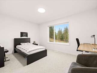 Discover this inviting bedroom featuring a comfortable bed with striped bedding and a dark wood headboard.
