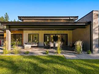 Experience modern luxury with this stunning home featuring a spacious covered patio perfect for outdoor entertaining.