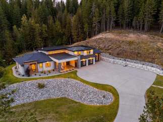 Experience modern luxury in this stunning custom-built home nestled amidst a serene forest.