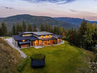 Experience luxury living in this stunning modern home nestled amidst breathtaking mountain views.