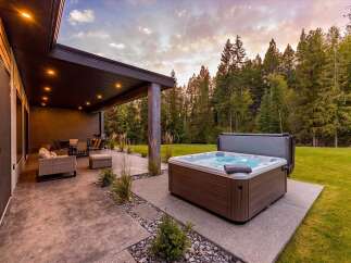 Experience ultimate relaxation in this stunning backyard oasis, featuring a luxurious hot tub perfect for unwinding under the stars.