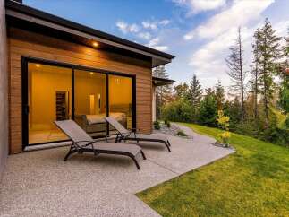 Experience modern luxury with this stunning home featuring expansive glass doors that seamlessly blend indoor and outdoor living.