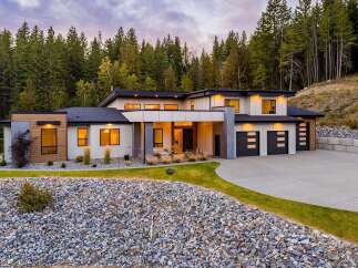 Discover modern luxury in this stunning contemporary home, nestled amidst a serene forest backdrop.
