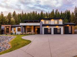Experience modern luxury in this stunning multi-level home, nestled amongst a serene forest backdrop.