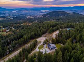 Experience luxury living in this stunning modern home nestled amidst a serene forest landscape.
