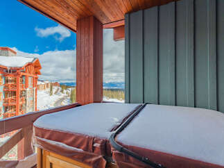 Enjoy breathtaking mountain views from this ski-in/ski-out condo, complete with a private hot tub on the balcony.