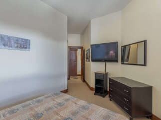 This cozy bedroom features a comfortable bed with a patterned comforter, perfect for a relaxing stay.