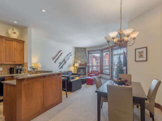 Experience modern mountain living in this beautifully appointed condo, featuring a fully equipped kitchen with granite countertops and a breakfast bar.