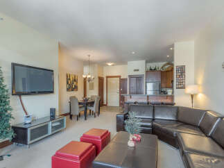 Experience comfortable living in this spacious open-concept condo, featuring a modern kitchen with a breakfast bar perfect for casual dining.