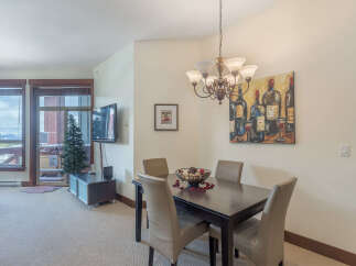 This inviting dining area features a dark wood table with four upholstered chairs, perfect for intimate meals.