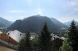 Experience breathtaking mountain views from this stunning property, featuring modern architecture and ample balconies perfect for enjoying the alpine scenery.