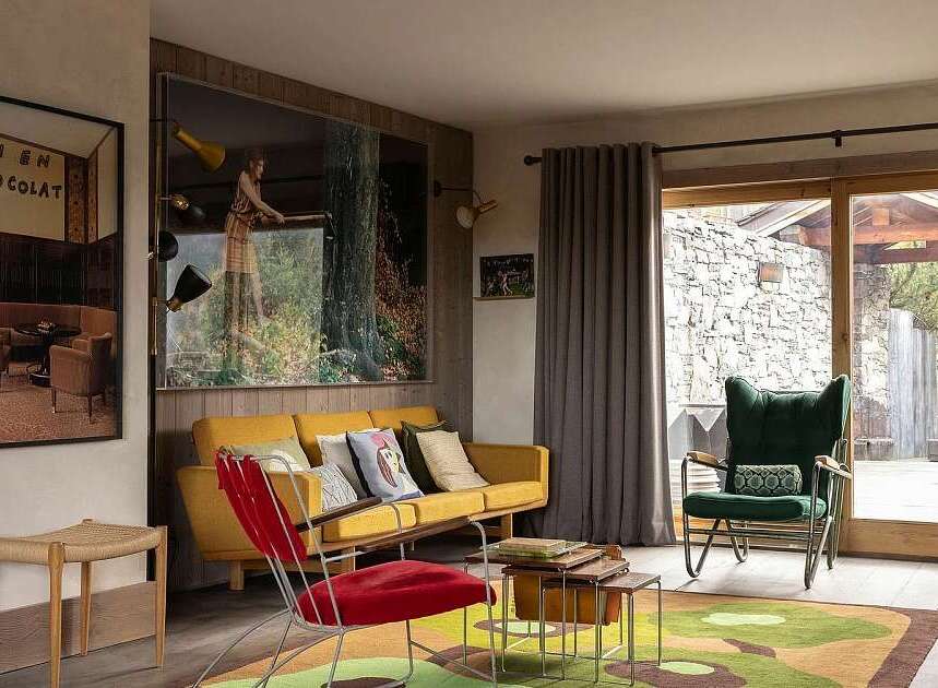Experience the unique charm of this living space, featuring a vibrant yellow sofa complemented by a striking red accent chair.