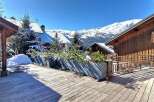 Experience the ultimate mountain retreat with this stunning property featuring a spacious wooden deck perfect for enjoying the crisp alpine air.