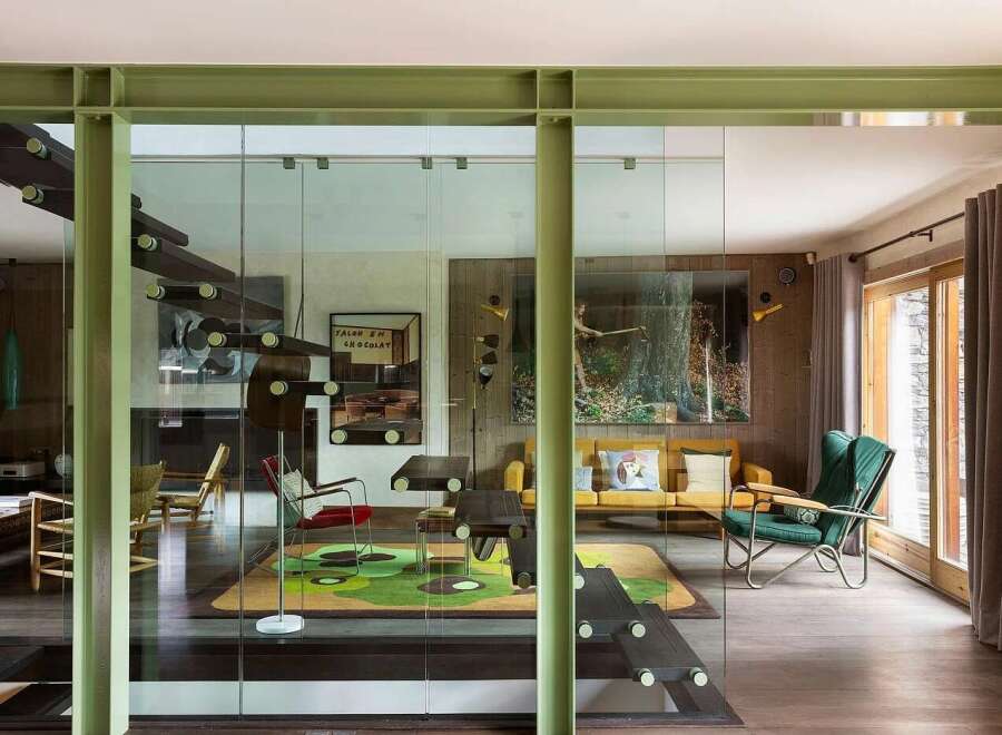 Experience modern living in this stunning home featuring a unique open-concept design with glass walls and exposed industrial beams.