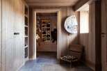 This entryway features a rustic wooden aesthetic with ample storage solutions for outdoor gear.