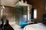 Experience luxury in this master bedroom featuring a stunning glass-enclosed shower with slate tile accents.