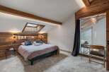 Experience rustic charm and modern comfort in this beautifully appointed bedroom, featuring a cozy bed with plush pillows and a stylish headboard.