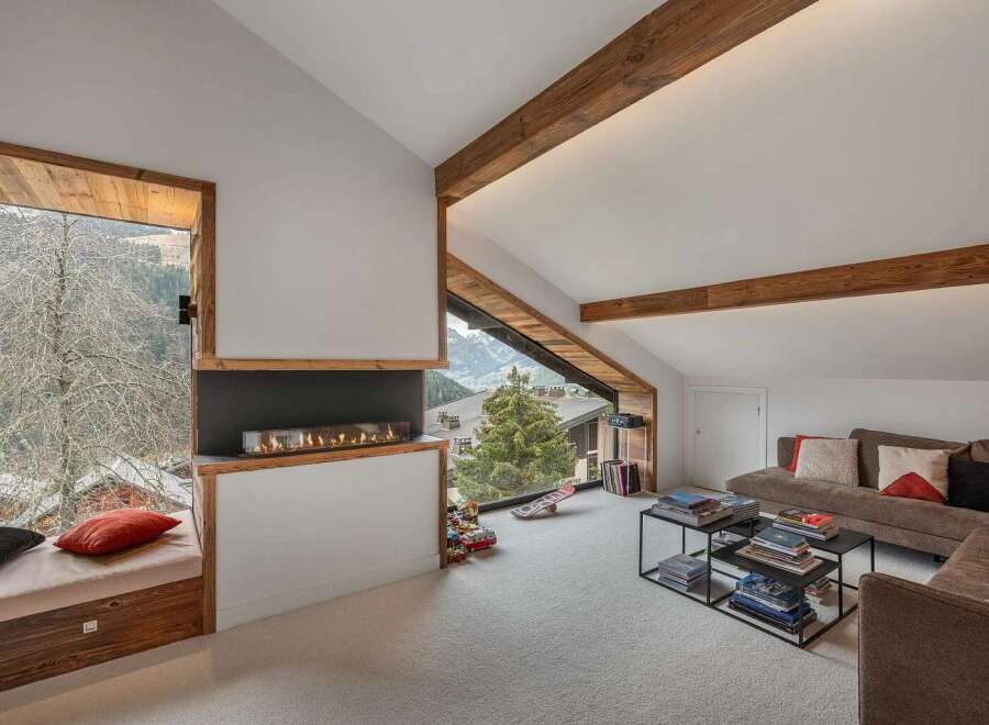 Experience cozy living in this modern mountain retreat, featuring a stunning gas fireplace as the centerpiece of the living area.