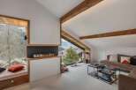 Experience cozy living in this modern mountain retreat, featuring a stunning gas fireplace as the centerpiece of the living area.