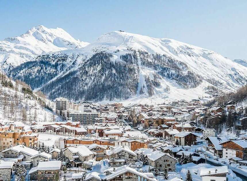Discover this charming ski resort nestled amidst majestic snow-capped mountains.
