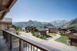 Experience the charm of alpine living in this picturesque village setting, featuring traditional stone and wood chalets nestled against a backdrop of majestic mountains.