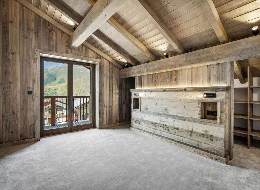 Experience luxurious mountain living in this stunning chalet-style bedroom.