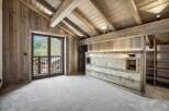 Experience luxurious mountain living in this stunning chalet-style bedroom.