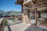 Experience breathtaking mountain vistas from this stunning wooden chalet, featuring a spacious balcony perfect for enjoying the alpine scenery.