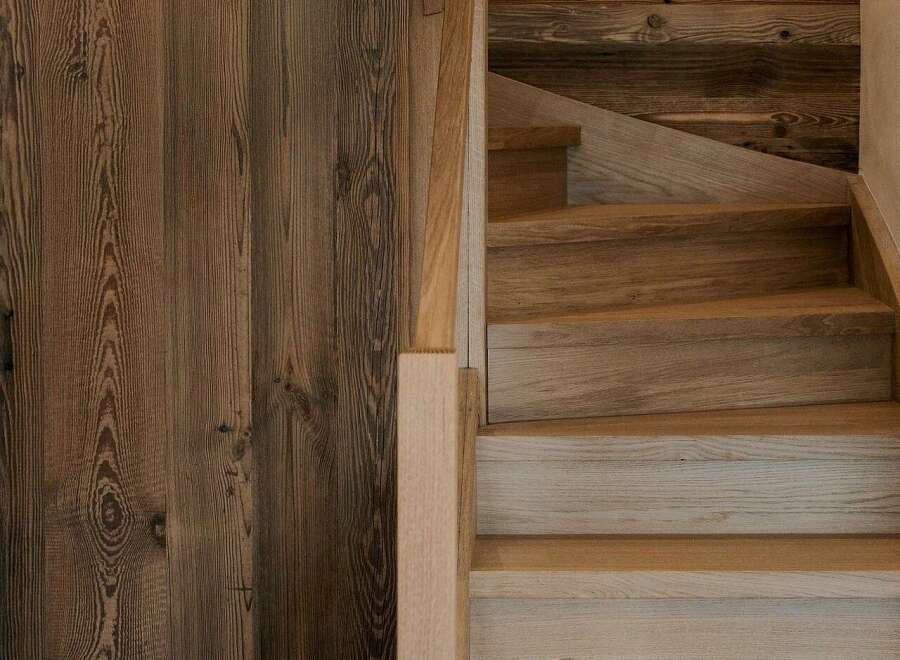 Experience rustic charm and modern elegance with this stunning wooden staircase and door.