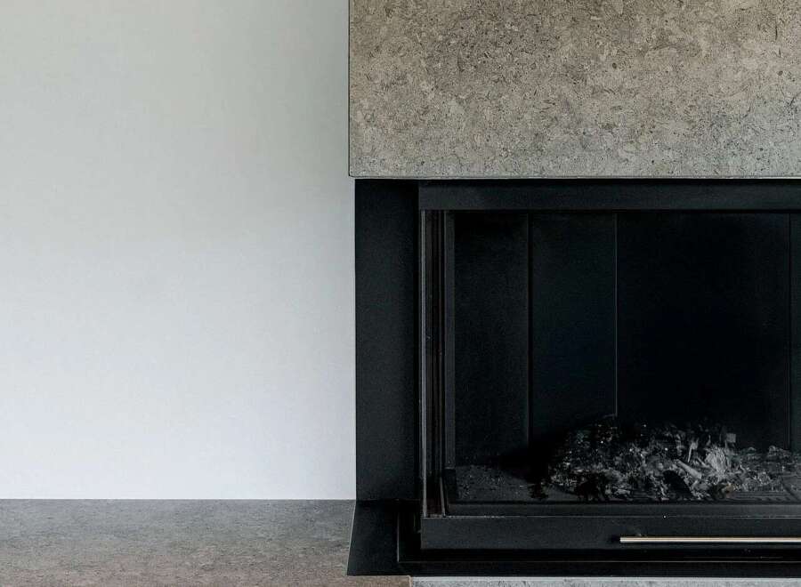 Experience modern living with this stunning fireplace featuring a sleek, minimalist design.