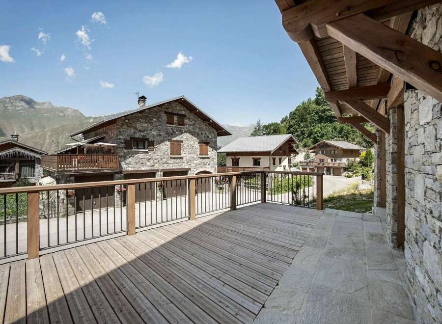 Experience the charm of mountain living with this stunning stone-built property, featuring a spacious wooden deck perfect for enjoying the breathtaking alpine scenery.