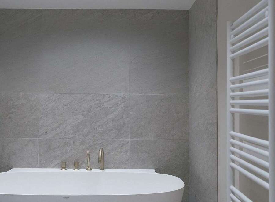 Experience modern luxury in this stunning bathroom, featuring a sleek, freestanding bathtub as the centerpiece.