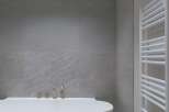 Experience modern luxury in this stunning bathroom, featuring a sleek, freestanding bathtub as the centerpiece.