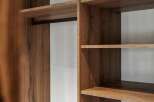 Discover organized living with this modern closet featuring a sleek hanging rod and ample shelving.