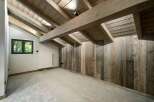 Experience rustic charm in this beautifully appointed room featuring exposed wooden beams and a vaulted ceiling.