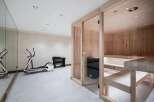 Transform your home into a personal wellness retreat with this modern gym and sauna space.