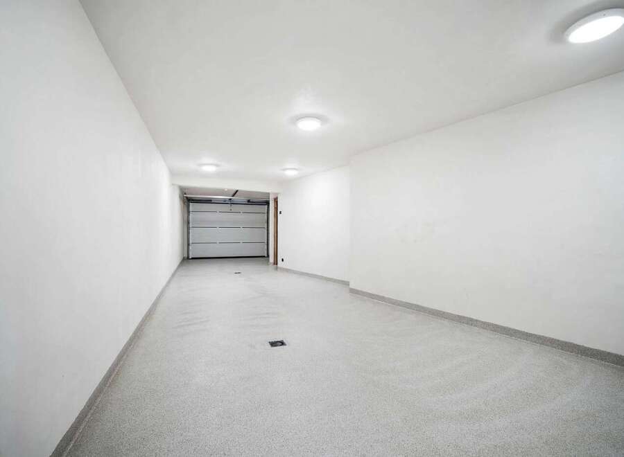 Discover this pristine, modern garage space, perfect for secure vehicle storage or as a versatile workshop area.