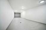Discover this pristine, modern garage space, perfect for secure vehicle storage or as a versatile workshop area.