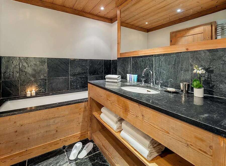 Indulge in a luxurious spa-like experience in this stunning bathroom, featuring a deep soaking tub perfect for relaxation and a spacious vanity with ample counter space.