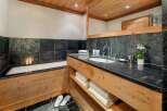 Indulge in a luxurious spa-like experience in this stunning bathroom, featuring a deep soaking tub perfect for relaxation and a spacious vanity with ample counter space.