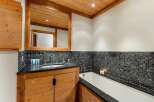 Experience luxury in this stunning bathroom featuring a deep soaking tub and a sleek vanity with a granite countertop.