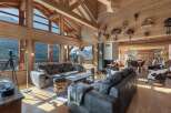 Experience luxurious mountain living in this stunning chalet, featuring a grand living area with a modern fireplace and breathtaking panoramic views.