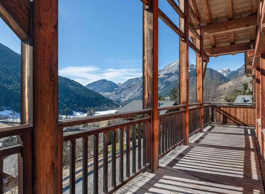 Experience breathtaking mountain views from this charming wooden balcony, perfect for enjoying your morning coffee or evening relaxation.