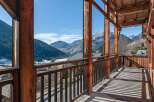 Experience breathtaking mountain views from this charming wooden balcony, perfect for enjoying your morning coffee or evening relaxation.