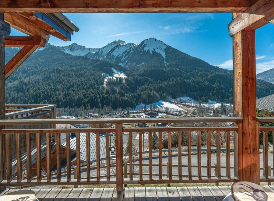Experience breathtaking mountain views from this charming wooden balcony, perfect for enjoying your morning coffee or evening relaxation.