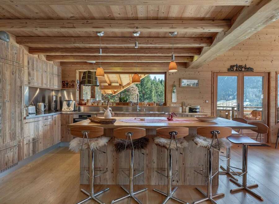 Experience rustic luxury in this stunning mountain kitchen, featuring warm wooden cabinetry and a spacious island perfect for entertaining.