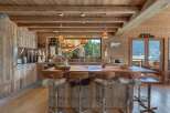 Experience rustic luxury in this stunning mountain kitchen, featuring warm wooden cabinetry and a spacious island perfect for entertaining.