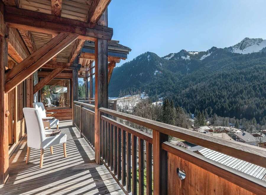 Experience breathtaking mountain views from this charming wooden balcony, perfect for enjoying your morning coffee or evening wine.