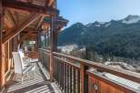 Experience breathtaking mountain views from this charming wooden balcony, perfect for enjoying your morning coffee or evening wine.