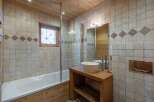Experience rustic charm in this bathroom, featuring a deep soaking tub and a wooden vanity with a vessel sink.